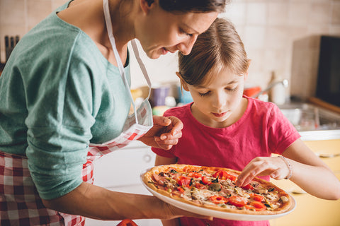mother and daughter making pizza